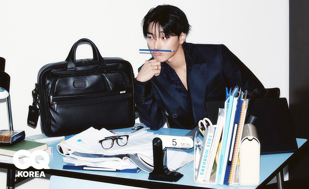 HBgrv0TXUAAGfFL San sitting at a desk with a pen resting on his upper lip to promote the new TUMI collection